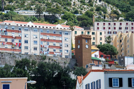 Clock tower and apartments clinging to the rock, Gibraltar, United Kingdom, Western Europe.のeditorial素材