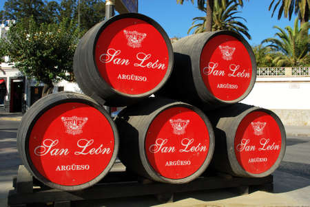 San Leon Argueso sherry barrels stacked on the roadsise, Sanlucar de Barrameda, Cadiz Province,...