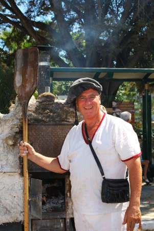 Medieval baker standing in front of his ovens at the Medieval market, Barbate, Cadiz Province, Andalusia, Spain, Western Europe.のeditorial素材
