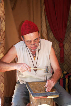 Ornate copper plate worker at the Medieval market, Barbate, Cadiz Province, Andalusia, Spain, Western Europe.のeditorial素材