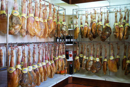 Legs of cured ham (Jamon Serrano) hanging in shop, Rute, Cordoba Province, Andalusia, Spain, Western...