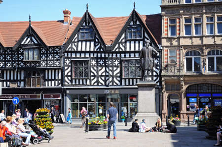 Timber framed buildings in The Square with a group of youngsters sitting around the base of the Clive of India statue (Robert Clive), Shrewsbury, Shropshire, England, UK, Western Europe.のeditorial素材
