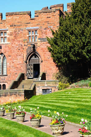View of the sandstone castle entrance with Spring flowers in the foreground, Shrewsbury, Shropshire, England, UK, Western Europe.の写真素材