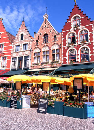 Tourists relaxing at pavement cafes in the Market Place Bruges Belgium Western Europe.のeditorial素材