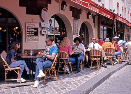 People relaxing at a pavement Cafe along the Place du Tertre in the city centre Paris France Western Europe.のeditorial素材