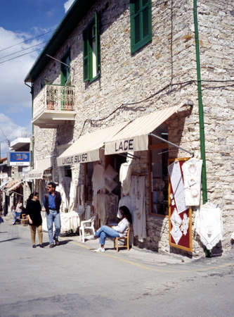 Couple walking past a lace shop in the town centre Pano Lefkara Cyprus.のeditorial素材