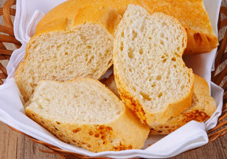 Crusty French stick cut into pieces in a bread basket.