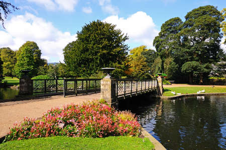Footbridge across the lake in the Pavilion Gardens, Buxton, Derbyshire, England, UK, Western Europe.の写真素材