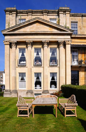 Wooden table and chairs outside the Royal Mews Georgian houses in Suffolk Square, Cheltenham, Gloucestershire, England, UK, Western Europe.のeditorial素材