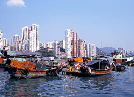 Sampans in the harbour with high rise buildings to the rear, Aberdeen, Hong Kong, Chinaのeditorial素材