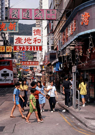 Chinese people crossing a busy shopping street, Aberdeen, Hong Kong, Chinaのeditorial素材