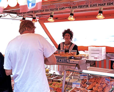 Market stall selling seafood and meat products, Volendam, Holland, Netherlands, Europe.のeditorial素材