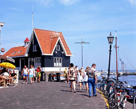 Tourists walking along the quayside street, Volendam, Holland, Netherlands, Europe.のeditorial素材