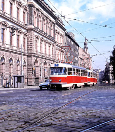 Red tram travelling through the city streets, Prague, Czech Republic, Central Europe.のeditorial素材