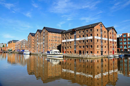 Boats moored in Gloucester Docks with warehouses to the rear, Gloucester, Gloucestershire, England, UK, Western Europe.のeditorial素材