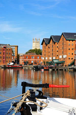 Boats moored in Gloucester Docks with warehouses and the Cathedral to the rear, Gloucester, Gloucestershire, England, UK, Western Europe.のeditorial素材