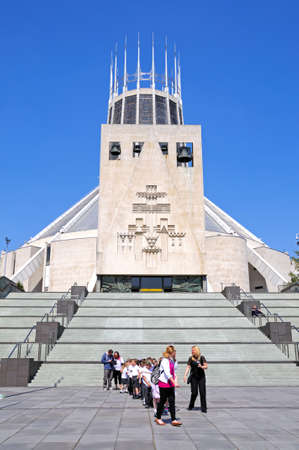 Teachers with a party of school children by the steps leading to the Roman Catholic Cathedral, Liverpool, Merseyside, England, UK, Western Europe.のeditorial素材