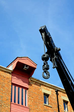 Black crane for loading and unloading into boats in Gloucester Docks, Gloucester, Gloucestershire,...