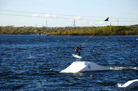Man wakeboarding on Chasewater lake, Chasewater County Park, Brownhills, West Midlands, England, UK, Western Europe.のeditorial素材