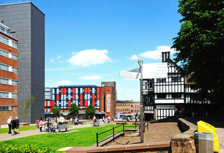Small park along Trinity Street with The Flying Standard public house to the right hand side and a signpost in the foreground, Coventry, West Midlands, England, UK, Western Europe.のeditorial素材
