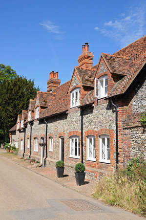 Pretty brick and flint cottages with dormer windows along a village street, Hambledon, Oxfordshire, England, UK, Western Europe.の写真素材