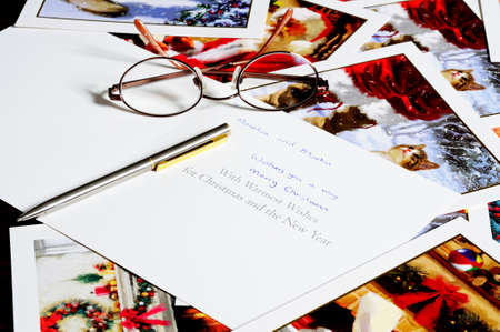 Scattered Christmas cards with glasses and a pen.のeditorial素材