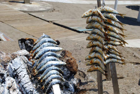 Cooked sardines on skewer in BBQ boat on beach, Fuengirola, Malaga Province, Andalusia, Spain, Western Europe.の写真素材