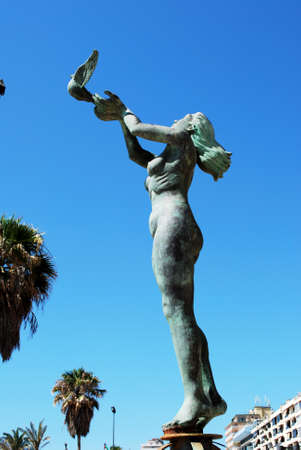 Statue of a woman releasing a dove along the promenade, Fuengirola, Malaga Province, Andalusia, Spain, Western Europe.の写真素材