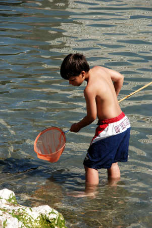 Boy fishing on the shoreline, Fuengirola, Malaga Province, Andalusia, Spain, Western Europe.のeditorial素材