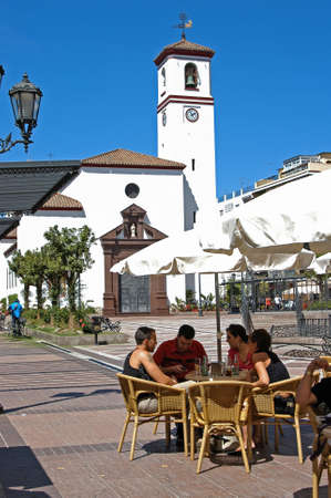 Pavement cafe in the Plaza de la Constitucion with the church to the rear, Fuengirola, Malaga Province, Andalusia, Spain, Western Europe.のeditorial素材