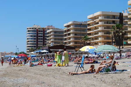 Holidaymakers relaxing on the beach with hotels and apartments to the rear, Fuengirola, Malaga Province, Andalusia, Spain, Western Europe.のeditorial素材