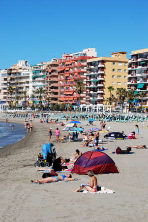 Holidaymakers relaxing on the beach with hotels and apartments to the rear, Fuengirola, Malaga Province, Andalusia, Spain, Western Europe.のeditorial素材