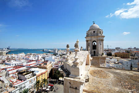 Eastern bell tower and rooftop statues on the Cathedral with views towards the port, Cadiz, Cadiz Province, Andalusia, Spain, Western Europe.のeditorial素材