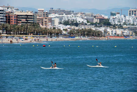 People in canoes with views of the beach to the rear, Benalmadena, Costa del Sol, Malaga Province, Andalusia, Spain, Western Europe.のeditorial素材