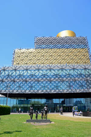 The Library of Birmingham with A Real Birmingham Family statue in the foreground in Centenary Square, Birmingham, England, UK, Western Europe.のeditorial素材