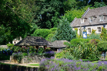 View across the trout farm garden towards The Swan Hotel, Bibury, Cotswolds, Gloucestershire,...