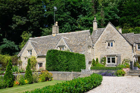 Pretty Cotswold cottages and gardens during the Summertime, Bibury, Cotswolds, Gloucestershire, England, UK, Western Europe.のeditorial素材