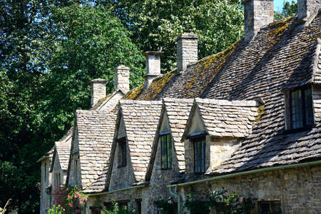 View of the dormer windows and roof of Arlington Row cottages, Bibury, Cotswolds, Gloucestershire, England, UK, Western Europe.のeditorial素材