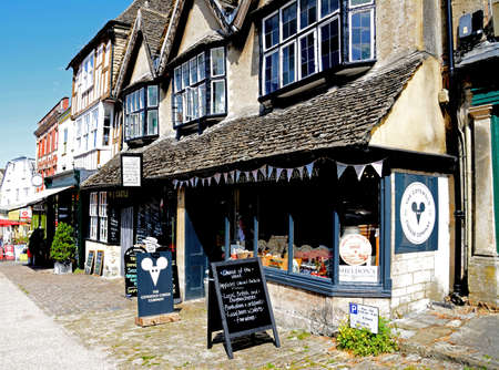 Shops along The Hill shopping street with the cheese shop in the foreground, Burford, Oxfordshire,...