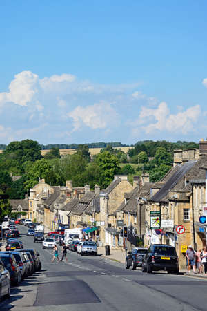 View along The Hill shopping street during the Summertime, Burford, Cotswolds, Oxfordshire, England,...