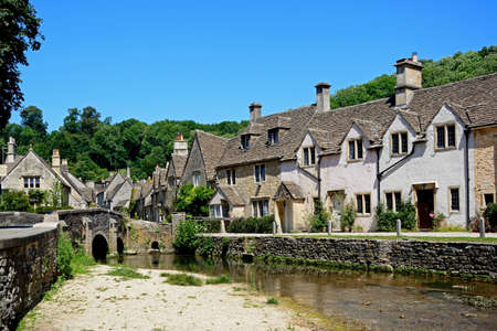 Stone cottages alongside the river Bybrook, Castle Combe, Wiltshire, England, UK, Western Europe.のeditorial素材
