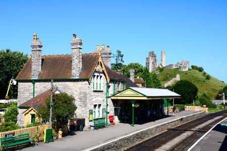 View of the railway station with the castle to the rear, Corfe, Dorset, England, UK, Western Europe.のeditorial素材