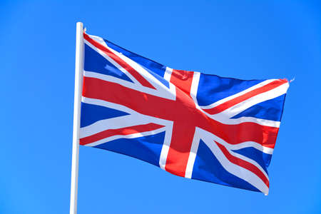 Union jack flag against a blue sky, UK.の写真素材