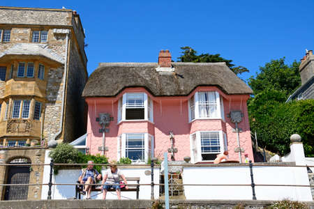 View of the pink painted thatched Library cottage along Marina Parade, Lyme Regis, Dorset, England, UK, Western Europe.のeditorial素材