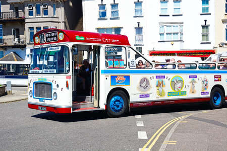 Bristol RE tour bus along a town centre shopping street, Seaton, Devon, England, UK, Western Europe.のeditorial素材