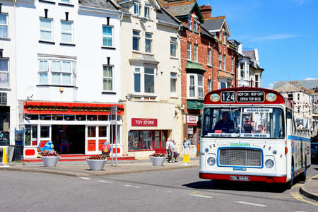 Bristol RE tour bus along a town centre shopping street, Seaton, Devon, England, UK, Western Europe.
