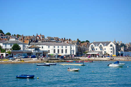 View of boats moored in the bay and the beach and town to the rear, Swanage, Dorset, England, UK,...