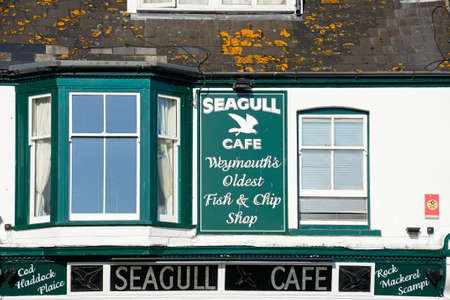 Traditional fish and chips shop signs along the Esplanade, Weymouth, Dorset, England, UK, Western Europe.のeditorial素材