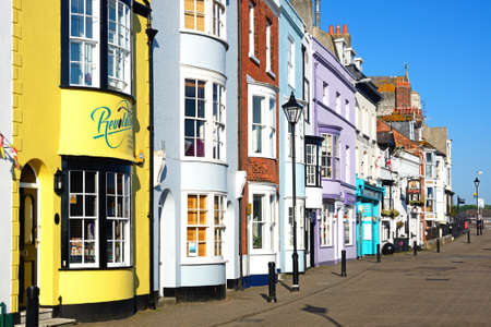Brightly painted buildings and shop fronts alongside the harbour, Weymouth, Dorset, England, UK, Western Europe.のeditorial素材