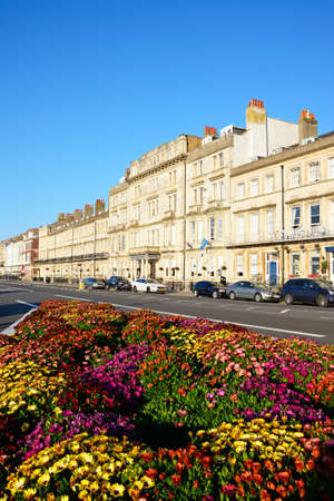 Row of guesthouses along the Esplanade promenade with pretty flowerbeds in the foreground, Weymouth, Dorset, England, UK, Western Europe.のeditorial素材